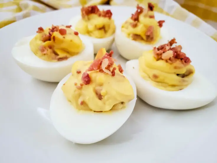 This is simply the best deviled eggs with bacon recipe you will ever try! It is a family favorite, and one of the most requested party side dishes anytime I host or attend.