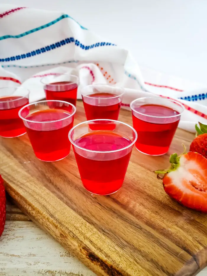 jello cups on wood boar with colorful towel